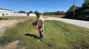 Self-storage owner and investor Kyle Grimm trimming the grass outside his new acquisition Self-storage owner and investor Kyle Grimm trimming the grass outside his new acquisition