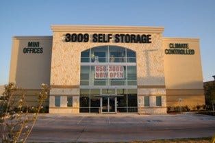 3009 Self Storage in Schertz, Texas shows how developers can maximize site layout with available land and use the building for signage. The doors are visible through the glass windows.