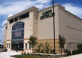 At 3009 Self Storage in Schertz, Texas, stone, storefront glazing and CMU patterning bring warmth to the dominant three-story facility. The entry is emphasized with south Texas limestone, and the roll-up doors are visible through the large expanses of front glass. The facility even glows at night!
