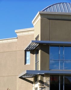 Eldridge Self Storage, Houston. Metal canopies shade expanses of glass, and highly detailed synthetic stucco emphasizes the entry and sophistication of this facility.