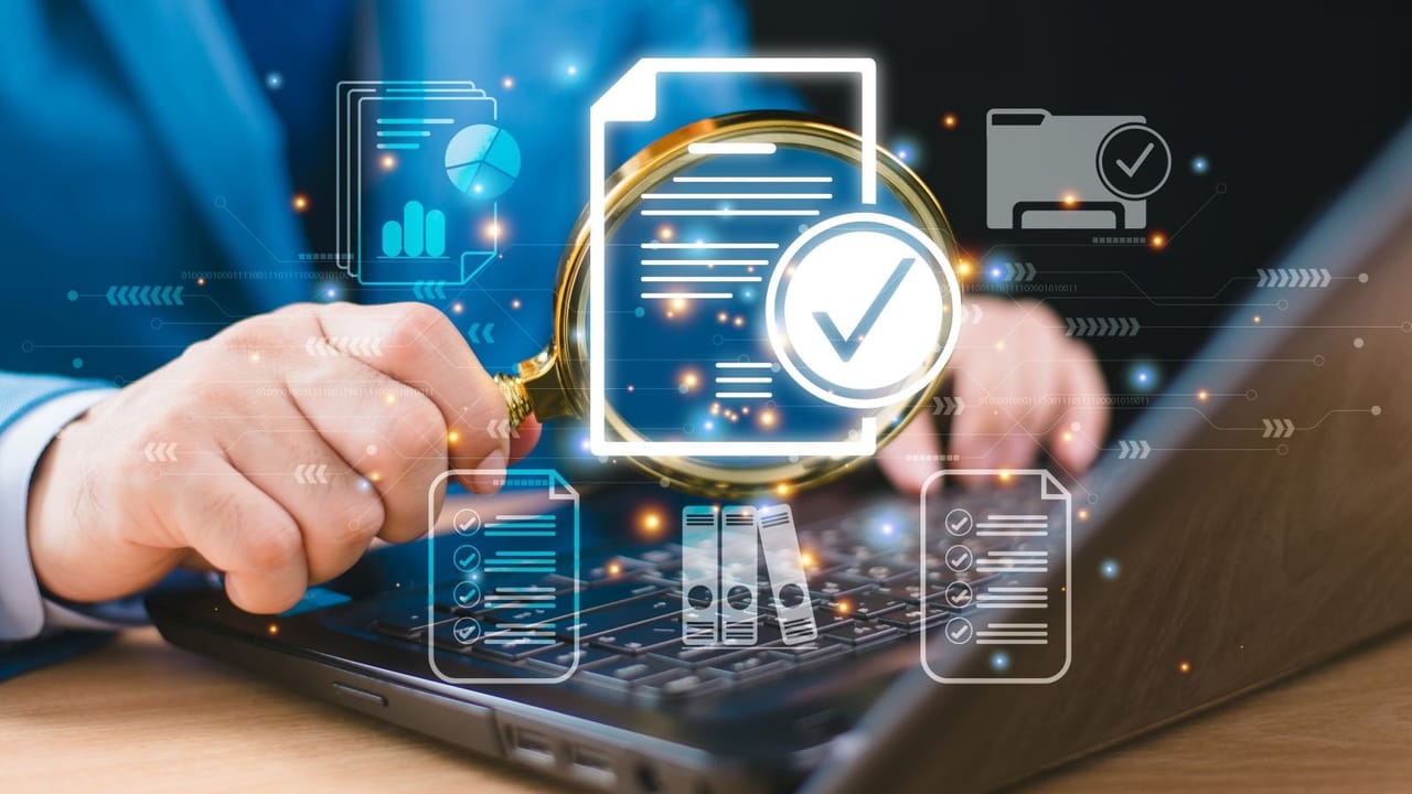 A hand holding a magnifying glass surrounded by digital document icons A hand holding a magnifying glass surrounded by digital document icons