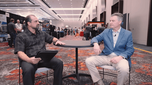 Two men sitting at a table talking Two men sitting at a table talking