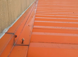 A roof fastener that has backed out of position