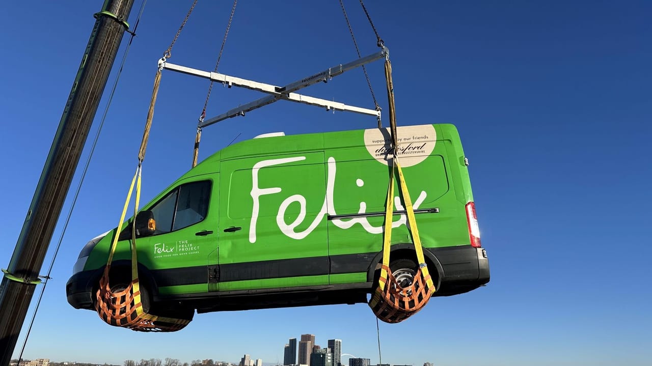 An image of The Felix Project green van being hoisted on top of a Vanguard Self Storage facility roof An image of The Felix Project green van being hoisted on top of a Vanguard Self Storage facility roof