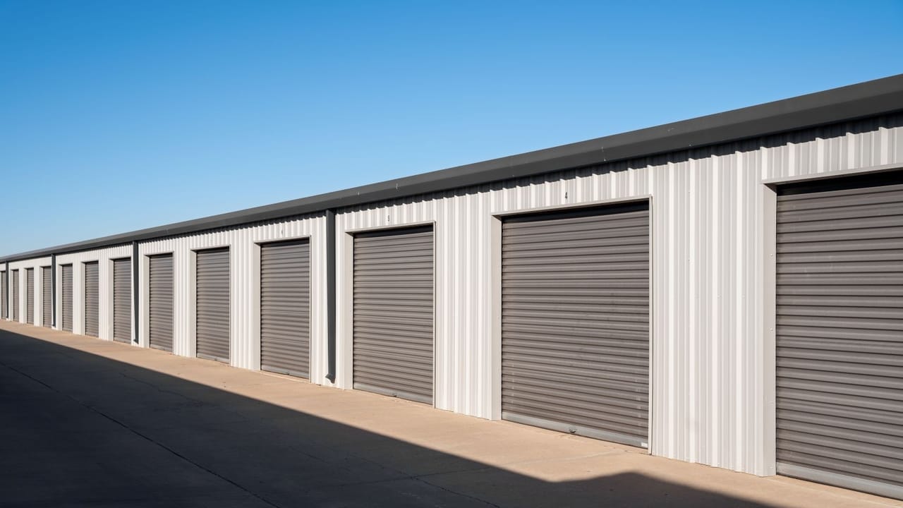 An image of a drive-up self-storage building with gray doors An image of a drive-up self-storage building with gray doors