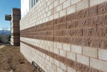 Using ground-face and split-face concrete masonry unit creates articulation and dynamism at nominal cost.