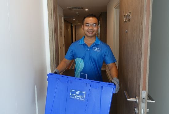 Employee Khoa Dang delivers bins to a customer