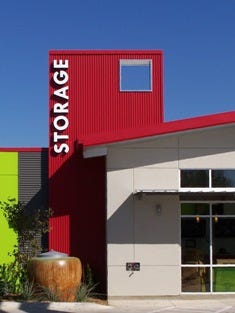 Premier Self Storage DeZavala, San Antonio, Texas. Diversity in metal panel colors, combined with a sustainable water-catchment cistern and bright green stucco create a dynamic focal point.