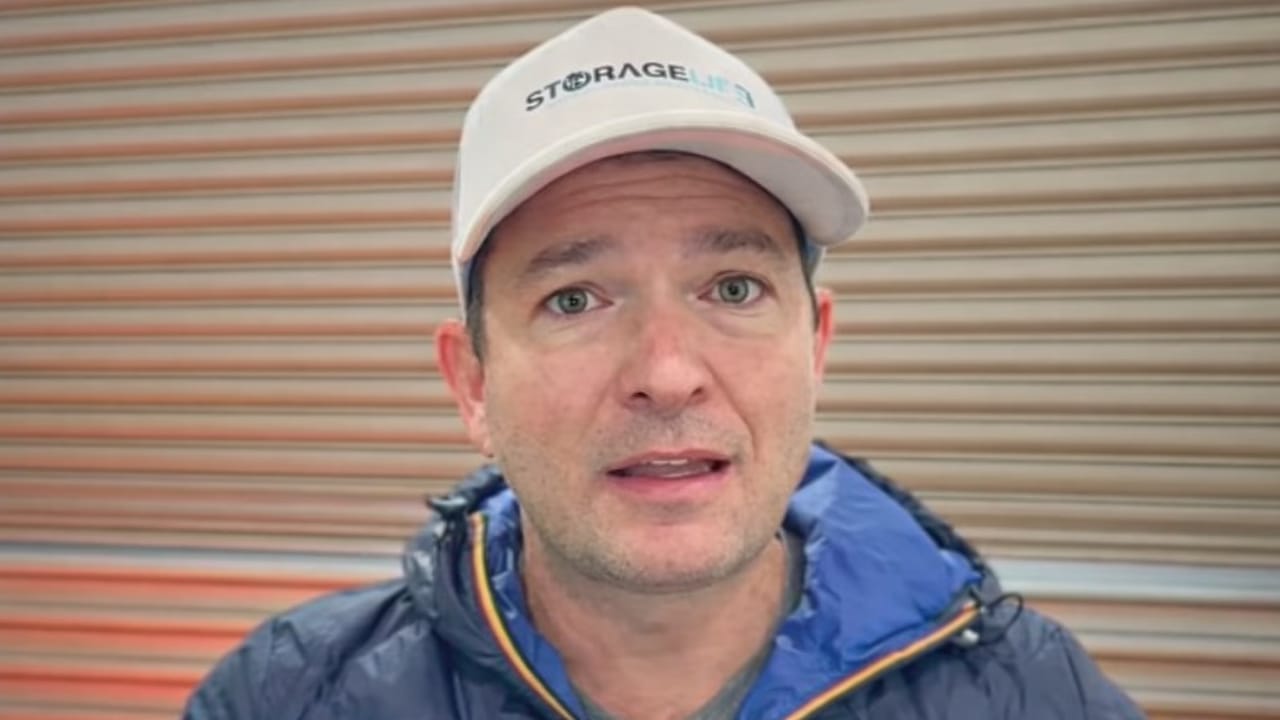 A man standing in front of a self-storage unit and talking A man standing in front of a self-storage unit and talking