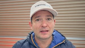 A man standing in front of a self-storage unit and talking A man standing in front of a self-storage unit and talking