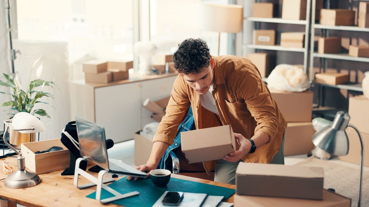 An image of a man at a desk with packages inside a flexspace office An image of a man at a desk with packages inside a flexspace office
