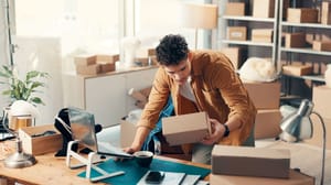 An image of a man at a desk with packages inside a flexspace office An image of a man at a desk with packages inside a flexspace office