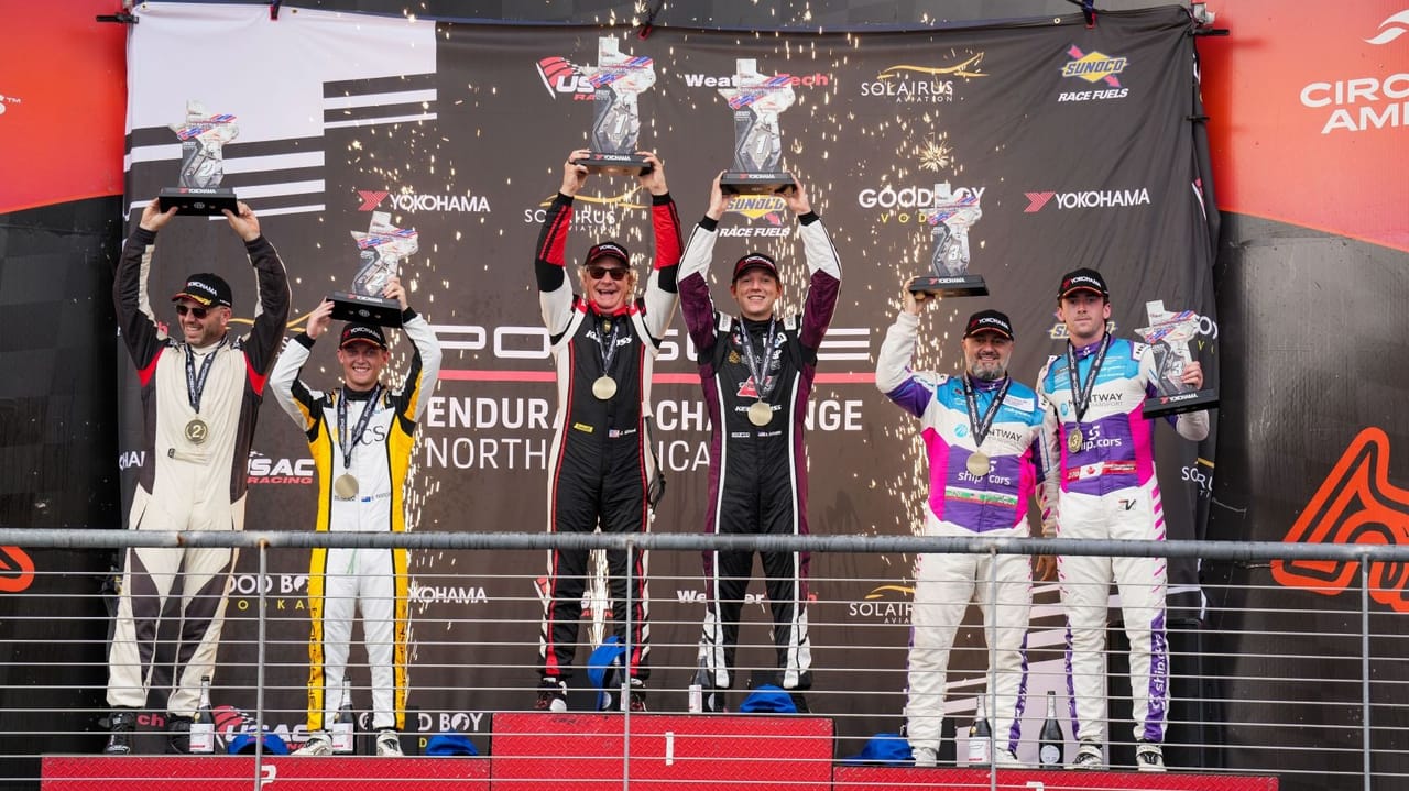 An image of the winners holding trophies for a racing championship An image of the winners holding trophies for a racing championship