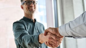 A man shaking hands with another person A man shaking hands with another person