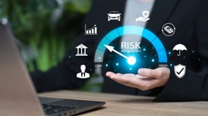 An open hand surrounded by virtual business icons and the words risk management above it An open hand surrounded by virtual business icons and the words risk management above it