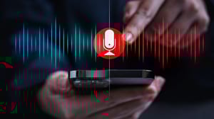An image of a person holding a phone and pressing play to listen to a podcast An image of a person holding a phone and pressing play to listen to a podcast