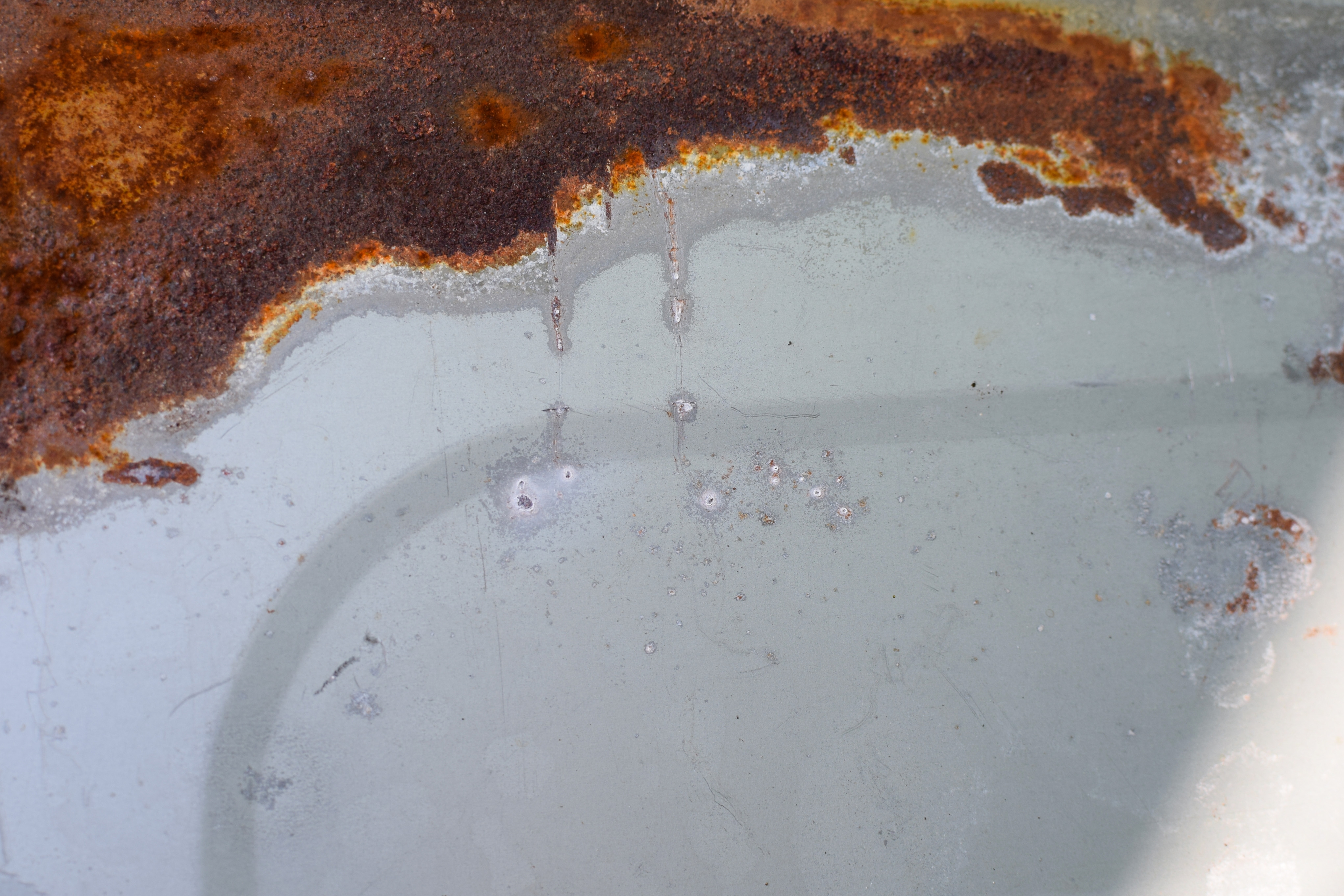 Rust coating a white surface.