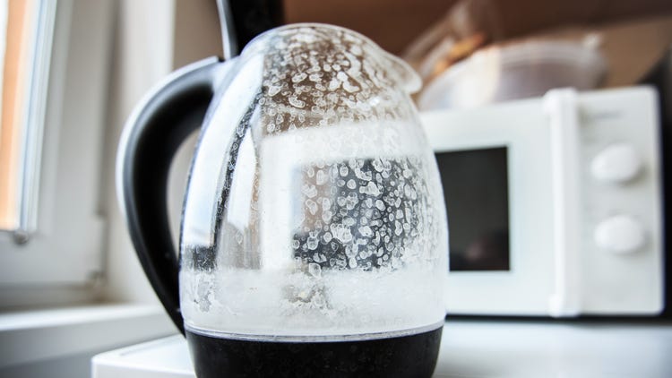 Glass coffee pot with cloudy residue showing hard water stains and buildup.