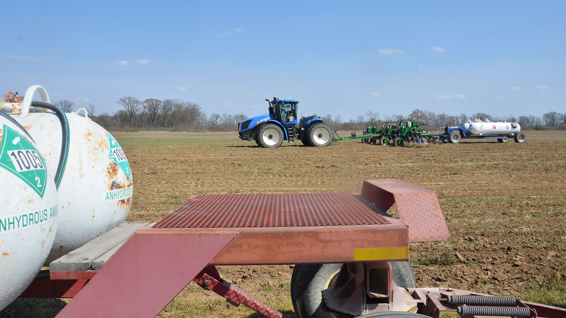 A tractor applying fertilizer to a field