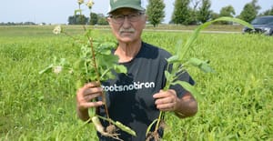 Keith Miller holds various cover crop plants Keith Miller holds various cover crop plants
