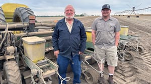 Joe and Knapp Boddiford beside corn planter. Joe and Knapp Boddiford beside corn planter.