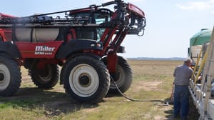farmer filling a sprayer farmer filling a sprayer