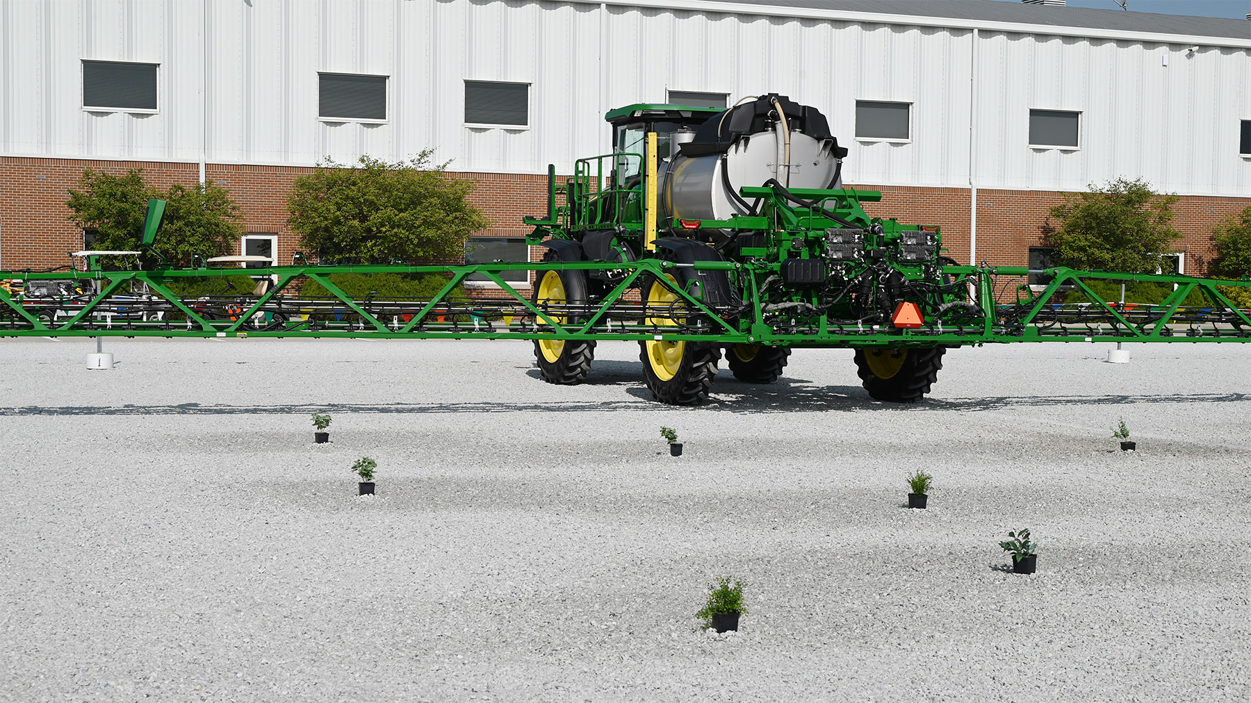 A sprayer displayed near a structure
