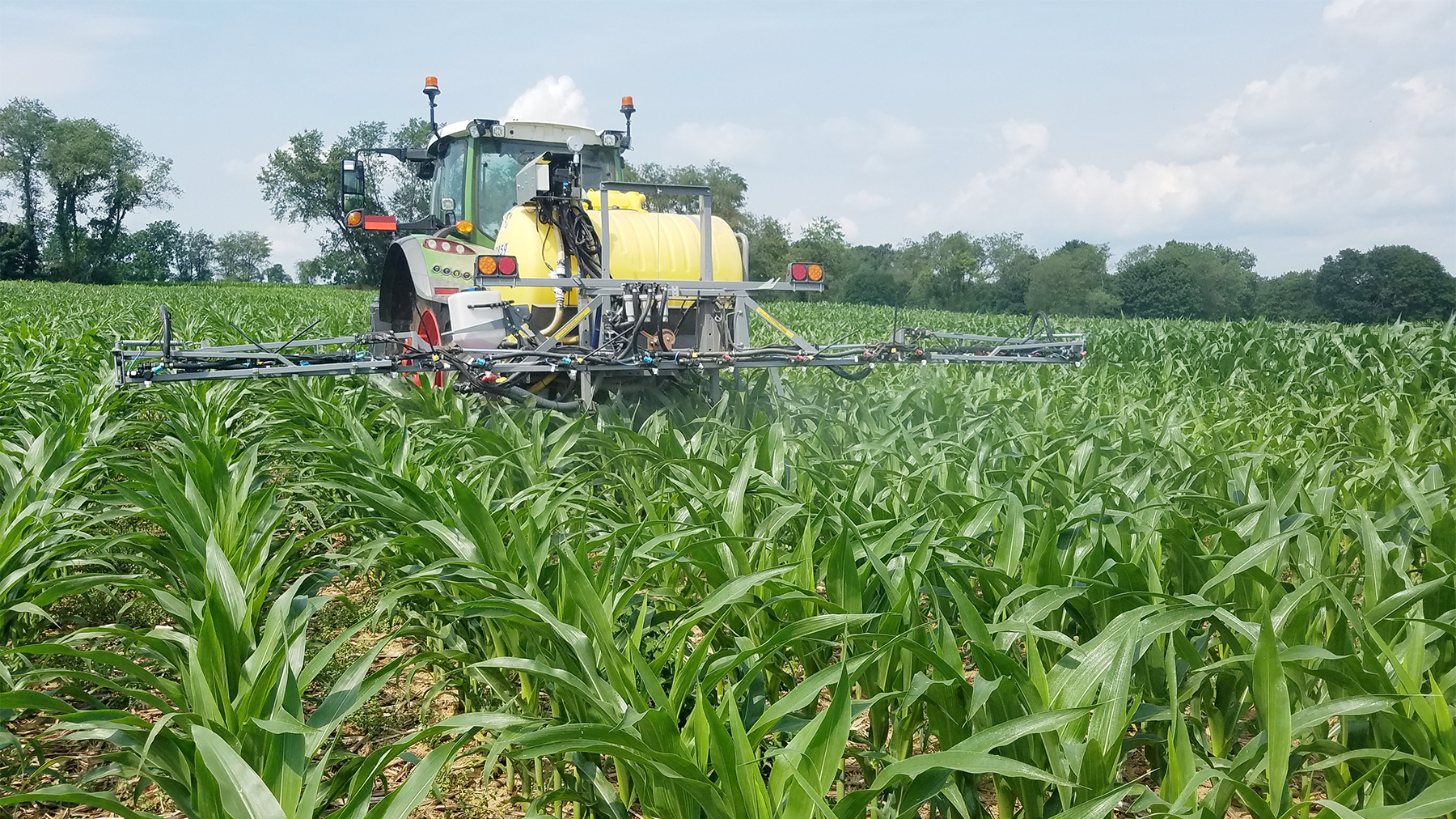 A tractor spraying a field